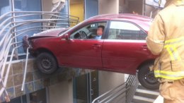 Car Crashes Into Building, Traps Driver
