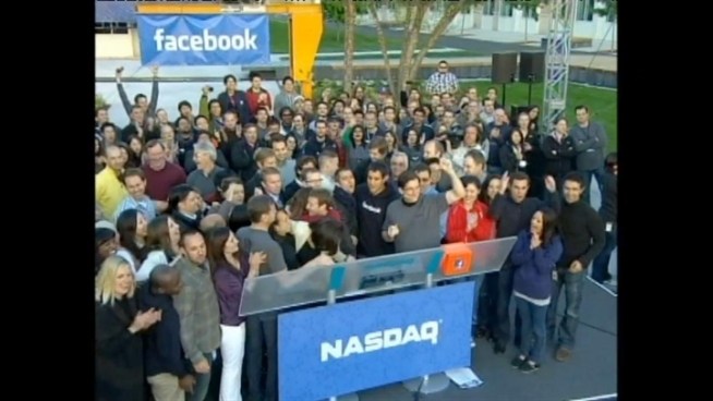 Mark Zuckerberg is pictured on a billboard in New York as Facebook goes public on Friday morning.