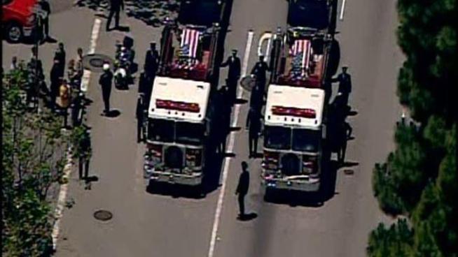 The bodies of two San Francisco firefighters who died in the line of duty were taken into a church for a memorial.
