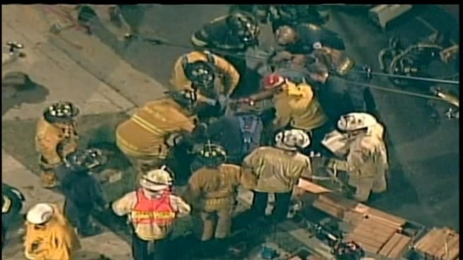 A man is rescued from a trench by firefighters.