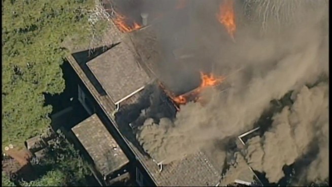 Smoke is billowing from the top floors of a wooden home in the 1100 block of Keith Avenue in Berkeley.