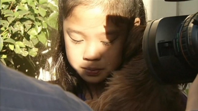 Little girl cries at the return of her stolen dog.