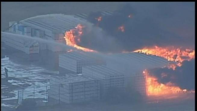 A large fire burned Tuesday afternoon at a plastics manufacturer in Fairfield near Travis Air Force Base.  A five acre parcel filled with stack of empty plastic crates burned for hours Tuesday afternoon.