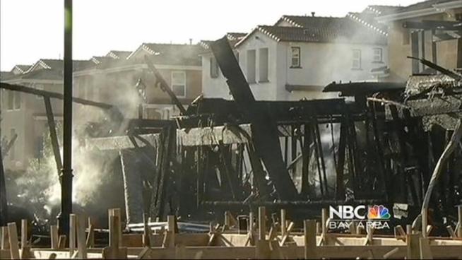 Santa Clara firefighters extinguished a five-alarm fire that  consumed several under-construction townhouses on Wednesday night, and  damaged several nearby buildings, a fire battalion chief said.