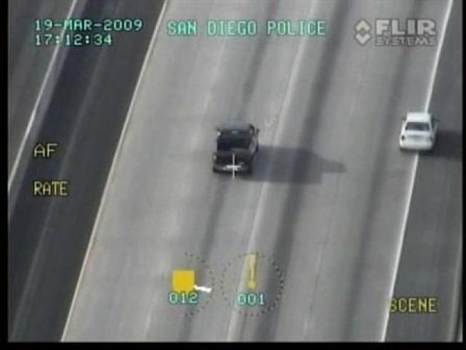 A suspect throws money out the window during a police pursuit through <a title=