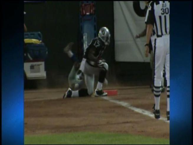 Dallas Cowboys cornerback DeAngelo Smith bowls over an NBC cameraman.