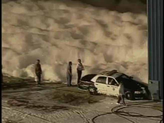 An accident release at the Long Beach Airport fills a police helicopter hangar with foam.