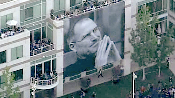 Apple employees gathered in Cupertino, Calif., for a private memorial service for Apple co-founder Steve Jobs on Oct. 19, 2011. A large pictures of Jobs were draped over Apple's buildings.