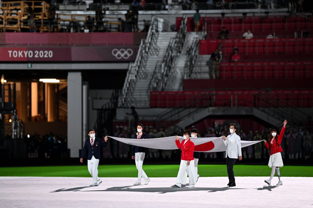 The Olympic flag is carried during the closing ceremony of the Tokyo 2020 Olympic Games, at the Olympic Stadium, in Tokyo, on Aug. 8, 2021.