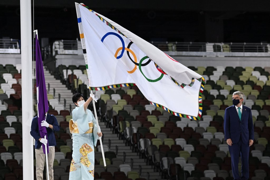 Tokyo's governor Yuriko Koike waves the Olympic flag during the closing ceremony of the Tokyo 2020 Olympic Games, at the Olympic Stadium, in Tokyo, on Aug. 8, 2021.