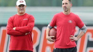 Head coach Kyle Shanahan of the San Francisco 49ers (R) talks with general manager John Lynch during practice for Super Bowl LIV at the Greentree Practice Fields on the campus of the University of Miami on January 29, 2020 in Coral Gables, Florida. (Photo by Michael Reaves/Getty Images)