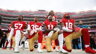 Eli Harold #57, Eric Reid #35, Marquise Goodwin #11 and Louis Murphy #18 of the San Francisco 49ers kneel on the sideline as Adrian Colbert #38 stands with them in solidarity, during the anthem, prior to the game against the Jacksonville Jaguars at Levi’s Stadium on December 24, 2017 in Santa Clara, California. The 49ers defeated the Jaguars 44-33. (Photo by Michael Zagaris/San Francisco 49ers/Getty Images)