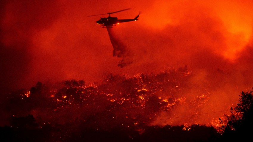 A helicopter drops water