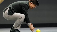 Hyun-Suk Kim, president and CEO of the Consumer Electronics Division at Samsung, demonstrates Ballie, an AI rolling robot during a Samsung keynote before the CES tech show, Monday, Jan. 6, 2020, in Las Vegas. (AP Photo/John Locher)