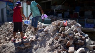Store owners and family help remove supplies from Ely Mer Mar hardware store, which partially collapsed after an earthquake struck Guanica, Puerto Rico, Tuesday, Jan. 7, 2020. A 6.4-magnitude earthquake struck Puerto Rico before dawn on Tuesday, killing one man, injuring others and collapsing buildings in the southern part of the island.