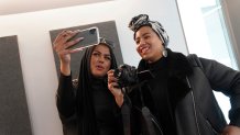 In this Dec. 19, 2019, photo, Amani Al-Khatahtbeh, left, films a video with Maryam Saad after recording a podcast pilot at Spotify's headquarters in New York. 