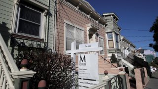 This Feb. 18, 2020, photo shows a real estate sign in front of a home for sale in San Francisco. On Thursday, Feb. 27, Freddie Mac reports on this week’s average U.S. mortgage rates.