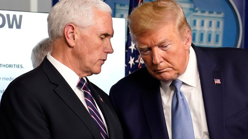 President Donald Trump listens to Vice President Mike Pence