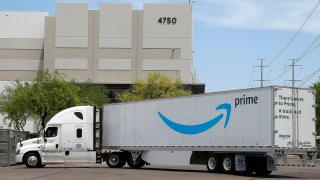 This July 17, 2019, file photo shows an Amazon shipping truck at a fulfillment center in Phoenix.