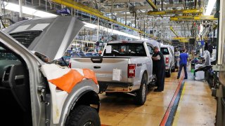 United Auto Workers assemblymen work on a 2018 Ford F-150 trucks being assembled at the Ford Rouge assembly plant in Dearborn, Mich.