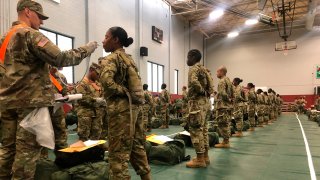 Army basic combat training graduates have their temperatures taken