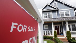 In this Wednesday, April 1, 2020 photo, a "For Sale" sign stands in front of a home that is in the process of being sold in Monroe, Wash., outside of Seattle.