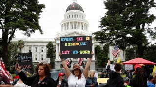 In this Monday, April 20, 2020, file photo, protesters calling for an end of Gov. Gavin Newsom's stay-at-home orders rally at the state Capitol in Sacramento, Calif.