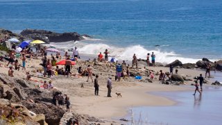 Several people utilize a beach, Friday, April 24, 2020, in Malibu, Calif. (AP Photo/Mark J. Terrill)