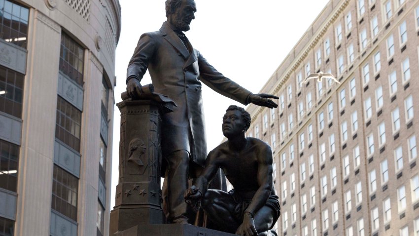 A statue depicting former President Abraham Lincoln standing before a freed black man is seen Saturday, June 13, 2020, in Boston. Boston’s mayor is considering the fate of the statue after a petition called for its removal. (AP Photo/Michael Dwyer)