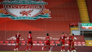 Liverpool's Trent Alexander-Arnold, right, celebrates after scoring the opening goal during the English Premier League soccer match