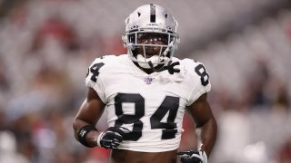 Wide receiver Antonio Brown #84 of the Oakland Raiders warms up before the NFL preseason game against the Arizona Cardinals at State Farm Stadium on August 15, 2019 in Glendale, Arizona.
