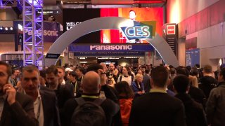 CES attendees pass under an archway in a crowded hallway of the Las Vegas Convention Center