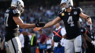 OAKLAND, CALIFORNIA – NOVEMBER 17: Derek Carr #4 of the Oakland Raiders celebrates with Foster Moreau #87 after scoring in the second quarter against the Cincinnati Bengals during their NFL game at RingCentral Coliseum on November 17, 2019 in Oakland, California. (Photo by Robert Reiners/Getty Images)