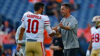 Jimmy Garoppolo and Kyle Shanahan of the San Francisco 49ers shake hands.