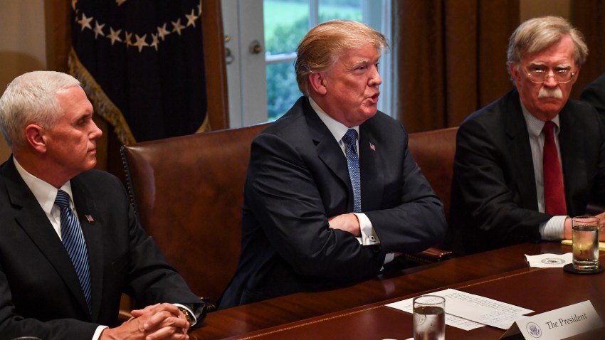 President Donald Trump, flanked by Vice President Mike Pence, left, and national security advisor John Bolton, right, speaks to the media in the White House on April 9, 2018, in Washington, D.C.