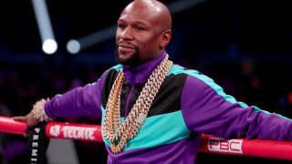 Floyd Mayweather Jr. stands in the ring before Errol Spence Jr takes on Mikey Garcia in an IBF World Welterweight Championship bout at AT&T Stadium on March 16, 2019, in Arlington, Texas.