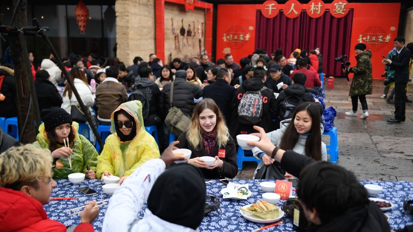 overseas students attend a long-table feast marking the upcoming Chinese Lunar New Year
