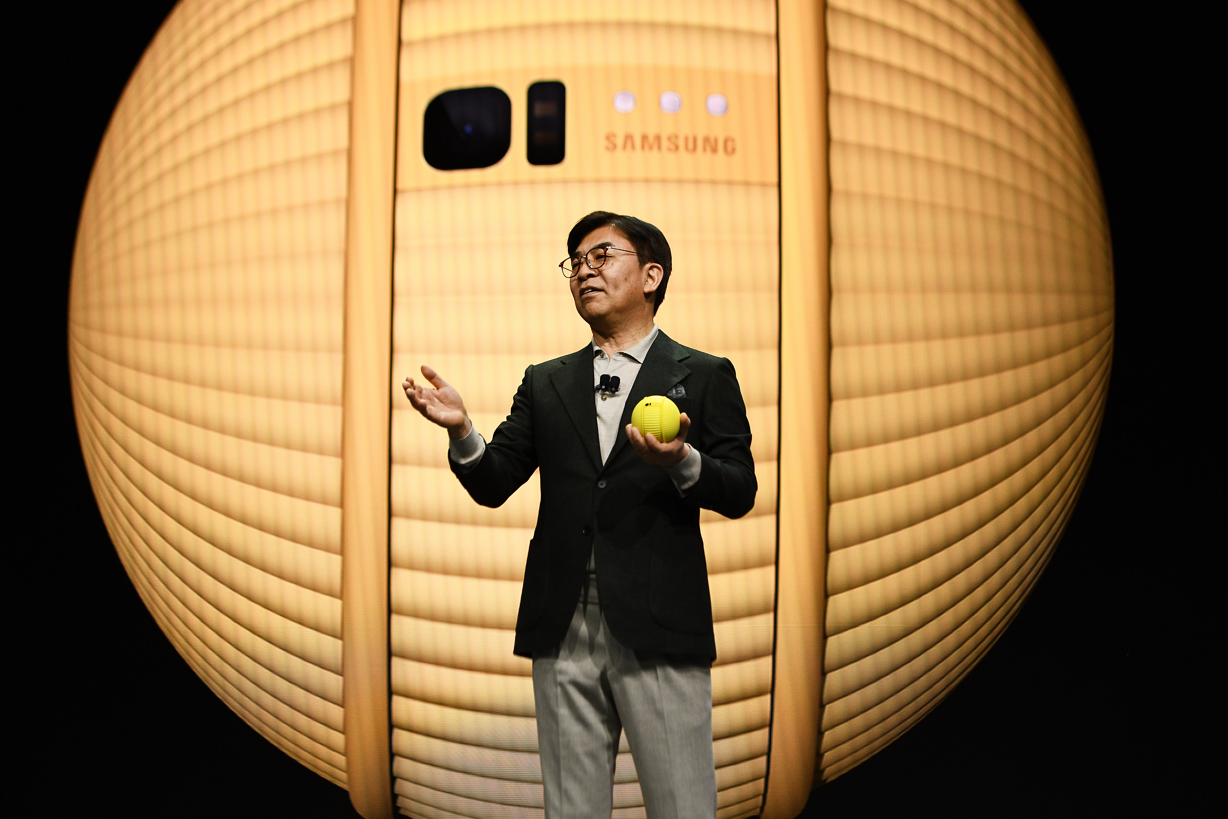 Kim Hyun-suk, president and co-chief executive officer of Samsung Electronics Co., presents the Ballie robot at CES 2020 in Las Vegas, Nevada, Monday, Jan. 6, 2020. The Ballie is a “personal care” robot that follows its user.