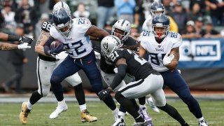 OAKLAND, CALIFORNIA – DECEMBER 08: Derrick Henry #22 of the Tennessee Titans runs the ball against Clelin Ferrell #96 and D.J. Swearinger #21 of the Oakland Raiders at RingCentral Coliseum on December 08, 2019 in Oakland, California. (Photo by Lachlan Cunningham/Getty Images)
