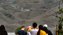 People arrive at the scene of a helicopter crash that killed Kobe Bryant, his 13-year-old daughter and seven others in Calabasas.