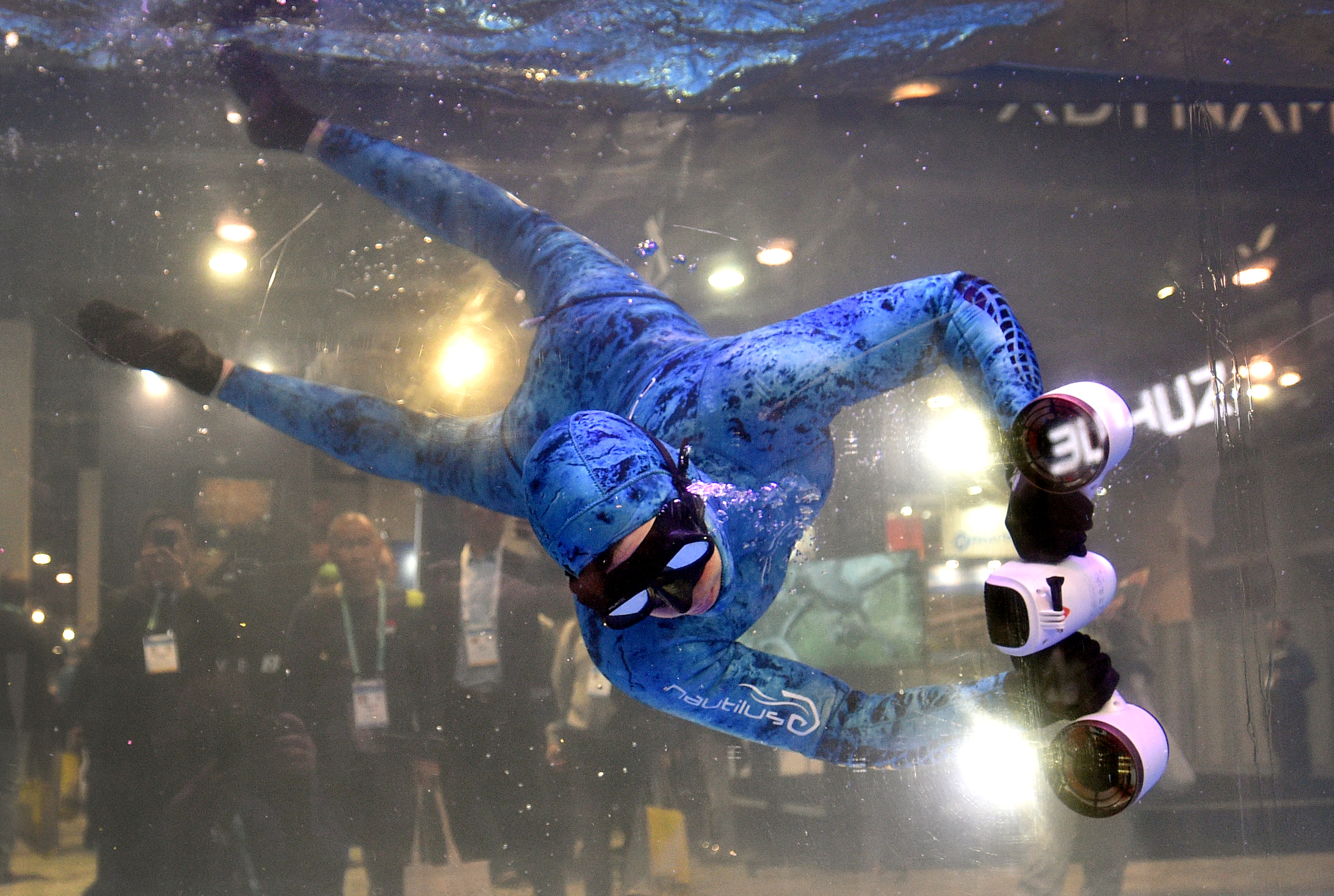 A model demonstrates Sublue’s White Mix Pro, a smart electric underwater scooter, during CES 2020 at the Las Vegas Convention Center on Jan. 8, 2020, in Las Vegas, Nevada.