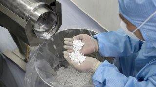 a pharmaceutical manufacturer employee checks the production of chloroquine phosphate