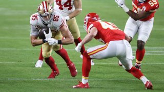 49ers' George Kittle is tacked by Kansas City Chief's Daniel Sorensen.