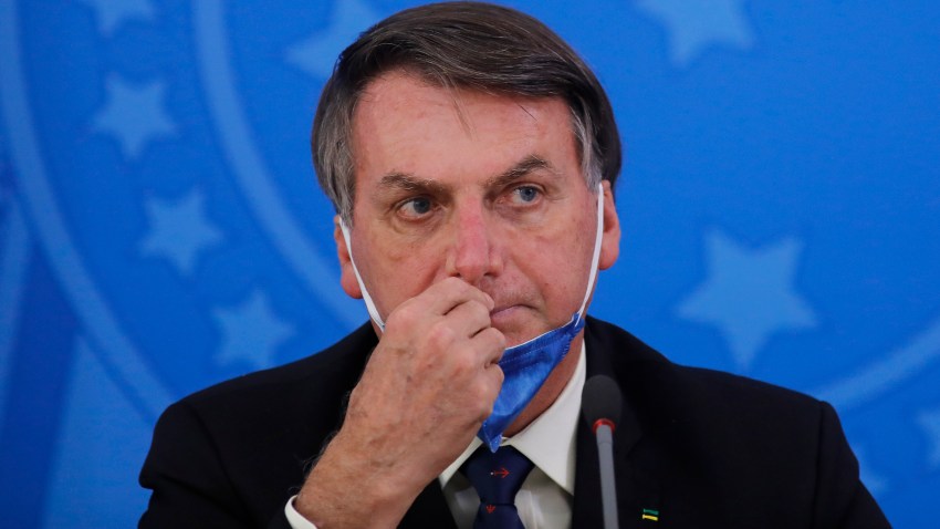 In this March 20, 2020, photo, Brazil's President Jair Bolsonaro attends a press conference on the coronavirus pandemic at the Planalto Palace in Brasilia, Brazil.