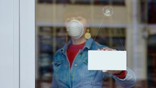 woman in closed shop with mask