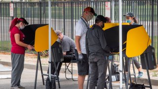 People vote at an early voting station for the special election between Democratic state assembly woman Christy Smith and Republican businessman and ex-Navy pilot Mike Garcia to replace former Democratic Congresswoman Katie Hill in the state's 25th Congressional District, in Lancaster, California on May 10, 2020.