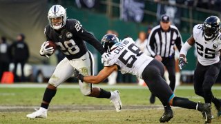 OAKLAND, CALIFORNIA – DECEMBER 15: Josh Jacobs #28 of the Oakland Raiders is tackled on a run by Austin Calitro #58 of the Jacksonville Jaguars during the second half at RingCentral Coliseum on December 15, 2019 in Oakland, California. (Photo by Daniel Shirey/Getty Images)