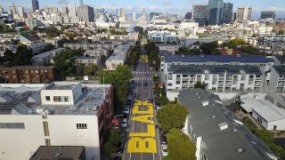 An aerial photo shows a giant street mural reading “Black Lives Matter” spanning three city blocks near City Hall in San Francisco, California on June 12, 2020.(Photo by Josh Edelson / AFP) (Photo by JOSH EDELSON/AFP via Getty Images)