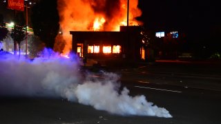 A Wendys restaurant burns after protesters allegedly set it on fire on June 13, 2020 in Atlanta, Georgia. Fresh protests rose up after an Atlanta police officer shot and killed Rayshard Brooks, an unarmed African American man outside the restaurant. .