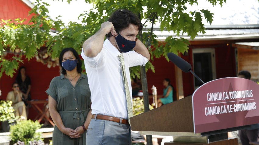 Justin Trudeau, Canada's prime minister, puts on a protective mask following a news conference in Chelsea, Quebec, Canada, on Friday, June 19, 2020. The federal government said earlier this month landlords had applied for only C$90 million ($66 million) from a rent assistance fund on behalf of about 26,000 tenants. That's less than 5% of its estimate of C$2 billion when the program was introduced in April.